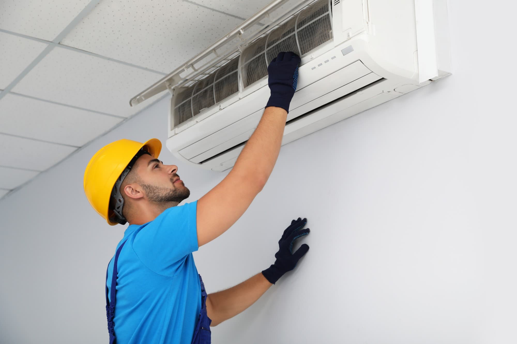 Technician cleaning an aircon unit